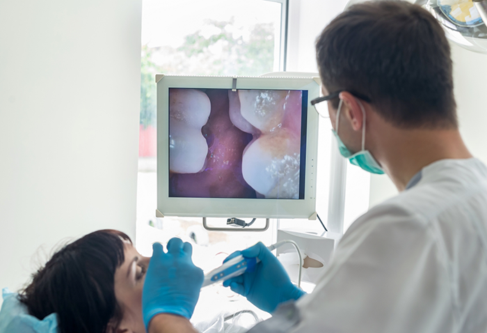 Dentist taking close up photos of a patient's teeth