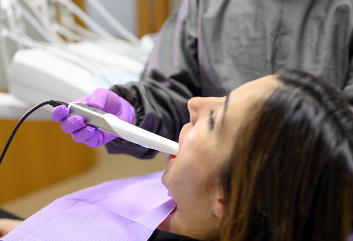 Dentist taking digital scans of a patient's teeth