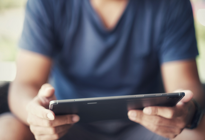 Person holding a tablet