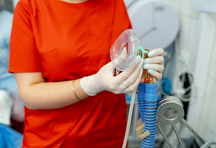 Dentist holding a nose mask for nitrous oxide sedation