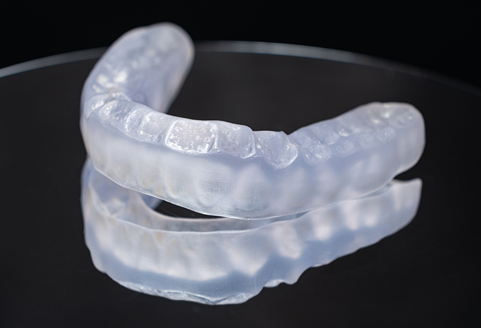 Clear nightguard tray against a black background