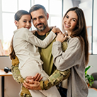 Family of three smiling in a dental office